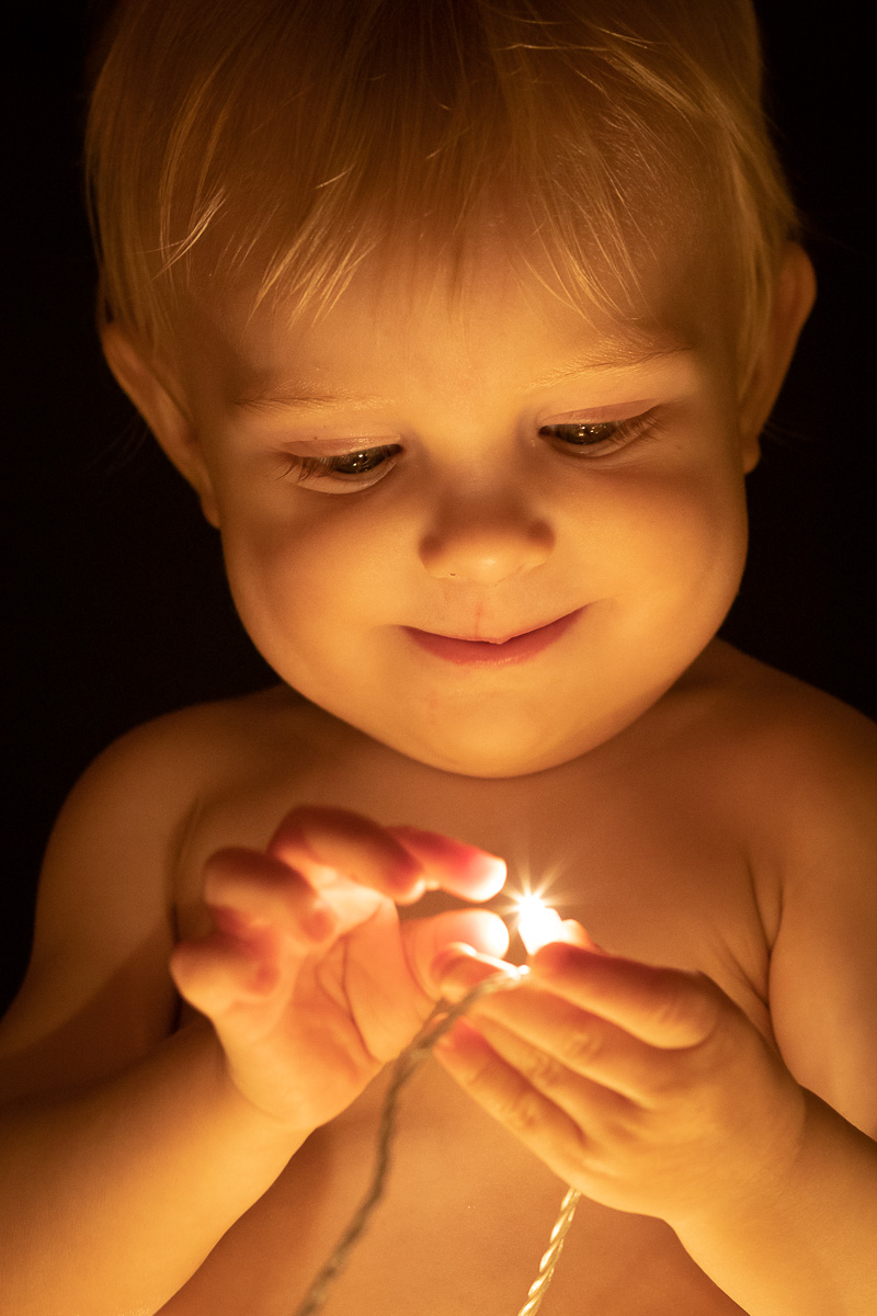 Baby kigger på lysekæde